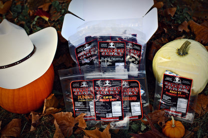Scary Good Beef Jerky Gift Box (10 bags): Matt-Hat Jerky gift box and bags of beef jerky laid out in an arrangement of pumpkins and leaves